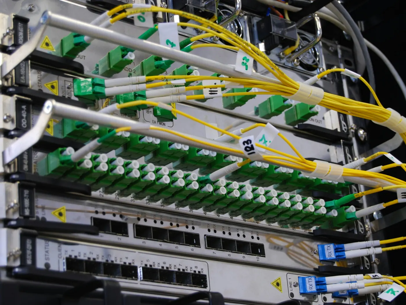 Yellow fibre-optic cables patched into a network switch