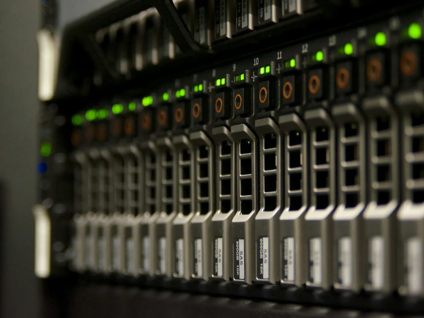 A server rack with rows of blinking green drive lights
